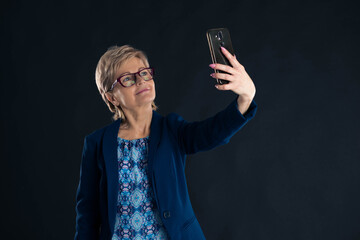 Older businesswoman taking a selfie