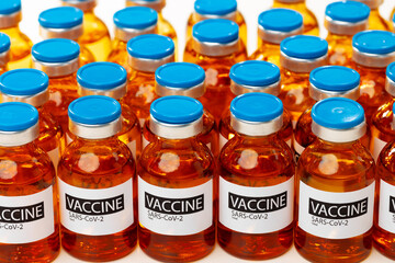 Sars-cov-2 vaccine vial bottles on white table