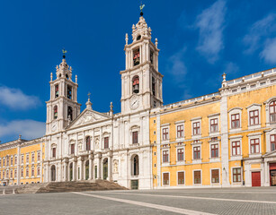 Main façade of the palace of Mafra, monumental Baroque and Neoclassical palace-monastery located in Mafra, Portugal.