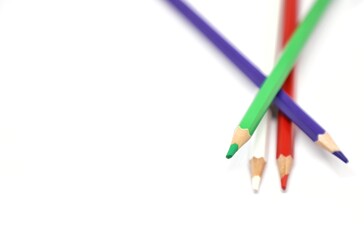 Colorful wooden color pencils isolated on white background-red, white, violet, red color pencils with text space at the left