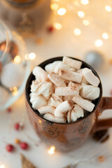 Christmas hot chocolate with marshmallow and gingerbread cookies on white wooden table. Traditional hot drink at Christmas.