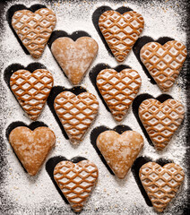 Heart-shaped gingerbread cookies top view. Christmas background with traditional festive cookies