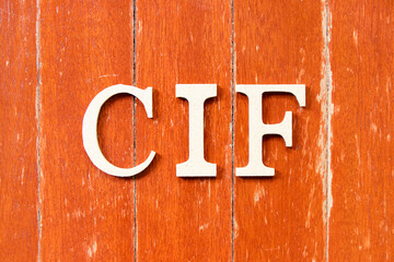 Alphabet letter in word CIF (Abbreviation of Cost, insurance, and freight) on old red color wood plate background
