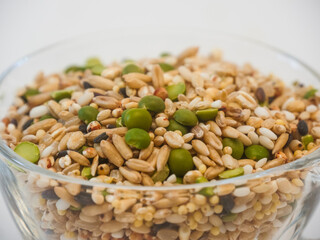 Close up of Miscellaneous grains in transparent glass cup isolated