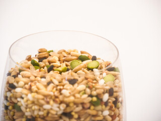 Close up of Miscellaneous grains in transparent glass cup isolated
