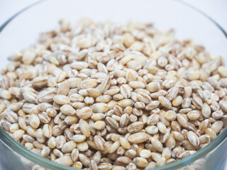 Close up of Unhulled barley in transparent glass cup