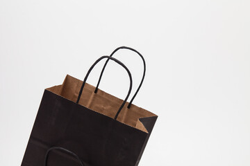 Empty black paper shopping bag on white 