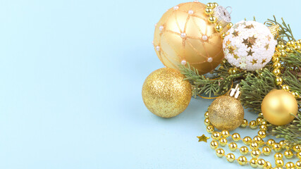 Christmas background, golded christmas balls and golden decoration on blue pastel background, horizontal new year web banner, place for text