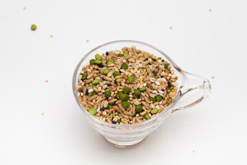 Miscellaneous grain in transparent glass cup isolated on white background