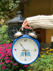 person holding clock