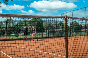 Silhouette of a active senior Caucasian couple in sportswear playing tennis