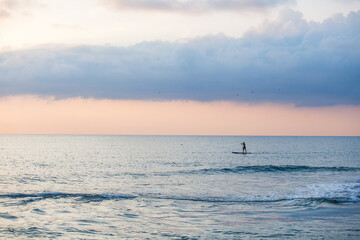 Fototapeta premium Sapboarder floats on the sea in Sochi, Russia