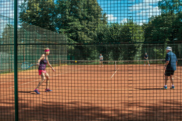 Silhouette of a active senior Caucasian couples in sportswear playing tennis
