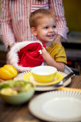 A happy little boy enjoying in the kitchen on a Xmas. Christmas, family, together