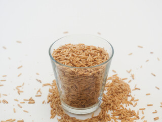 Oats in a transparent cup on white background