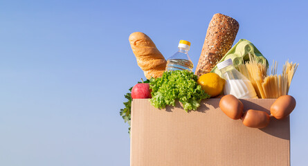 Cardboard box with groceries delivery or donation concept