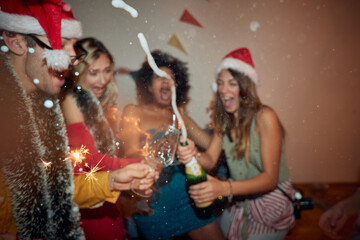 Blurred group of cheerful friends in midnight euforia at New Year eve home party. Friendship, together, party, New Year