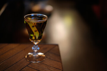 Whisky cocktail in vintage glass lemon peel, hot toddy