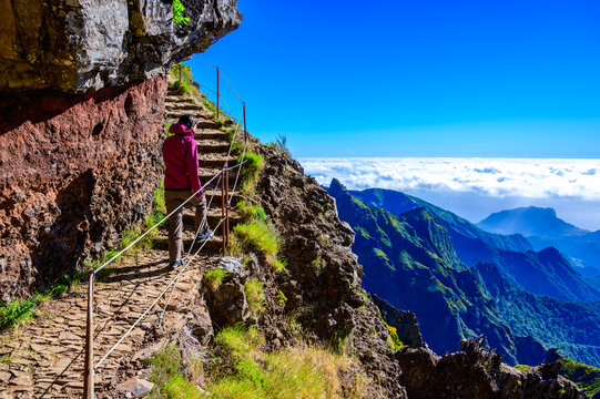 Beautiful hiking trail from Pico do Arieiro to Pico Ruivo, Madeira island. Footpath PR1 - Vereda do Areeiro. On summy summer day above the clouds. Portugal.