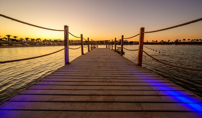 Fototapeta na wymiar Wooden Pier on Red Sea in Hurghada at sunset, View of the promenade boardwalk - Egypt, Africa