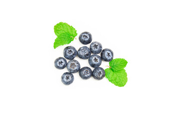 Group of blueberries together with some mint leaves on a white background