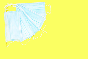 Corona virus face masks seen from above with a yellow background