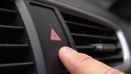 Pressing Car Hazard Emergency Lights Button Close Up