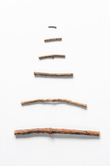 Christmas tree made of dried branches. Minimalistic concept for a greeting card, copy space.