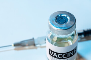 Covid-19 vaccine bottle with a syringe on lab table