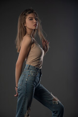 Portrait of beautiful girl posing in studio on grey background. Isolated 