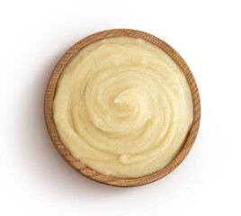 Mashed potato puree in wooden bowl isolated on white background, top view