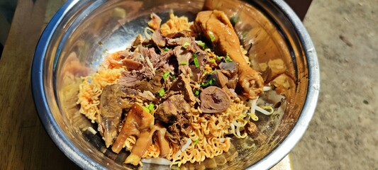 Dried instant noodles with chicken offal, leg, drumstick and feet.