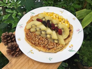 Coconut vanilla pancake with kiwi fruits and roast coconut