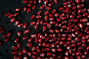 Scattered beautiful, juicy, ripe, red pomegranate seeds. texture. dense layer