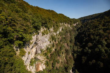 deep canyon between green mountains
