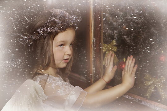 Little girl with angel wings in christmas decorations