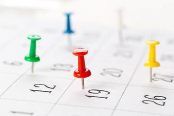 Push pins on calendar. Idea concept of to do planning.