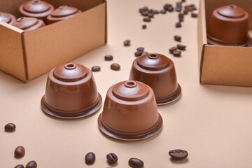 Coffee machine pods, capsules on beuge background