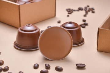 Coffee machine pods, capsules on beuge background