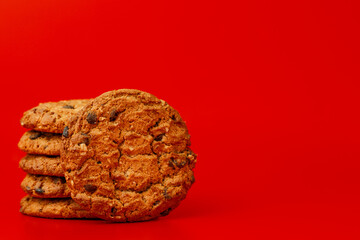 Chocolate chip cookies in stack on red background
