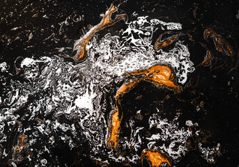 Luxury abstract fluid art painting in alcohol ink.  Imitation of marble stone, glowing golden veins on black blackground.