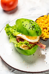 Ketogenic diet breakfast. avocado burger with bacon, egg, tomato, Keto, paleo lunch, Restaurant menu, dieting, cookbook recipe. vertical image, place for text