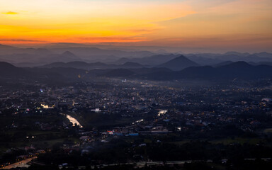 City surrounded by mountains at sunset, Phu Bo Bit view point, Loei, Thailand, Oct 26, 2020.
