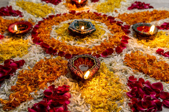 
Flower petal rangoli for Diwali with diwali diya selective focus
