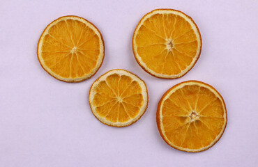 Fototapeta na wymiar White background with dried sliced oranges