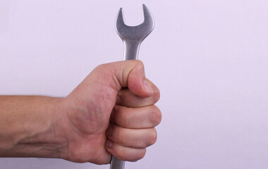 Male hand with wrench on white background