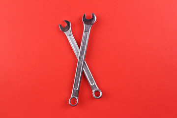 Red background with crossed wrenches