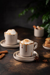 Hot winter cappuccino with cinnamon and caramel