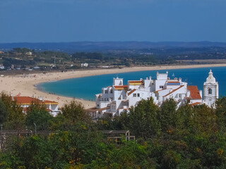 The beauty of Portugal - long beach of Lagos with the city church in front Lagos