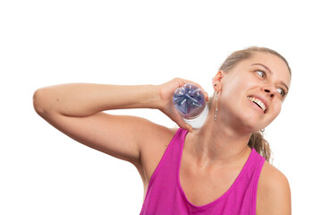 Female model touching neck with cold bottle to cool after workout